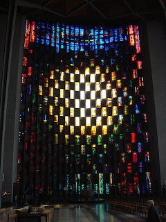 Colorful stained glass baptistry window with checkerboard pattern at Coventry Cathedral