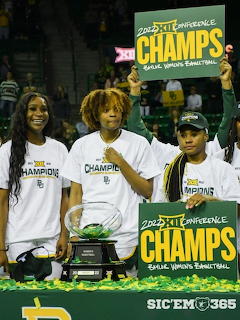 Three Baylor women's basketball players posing with championship trophy and Big 12 Champs signs