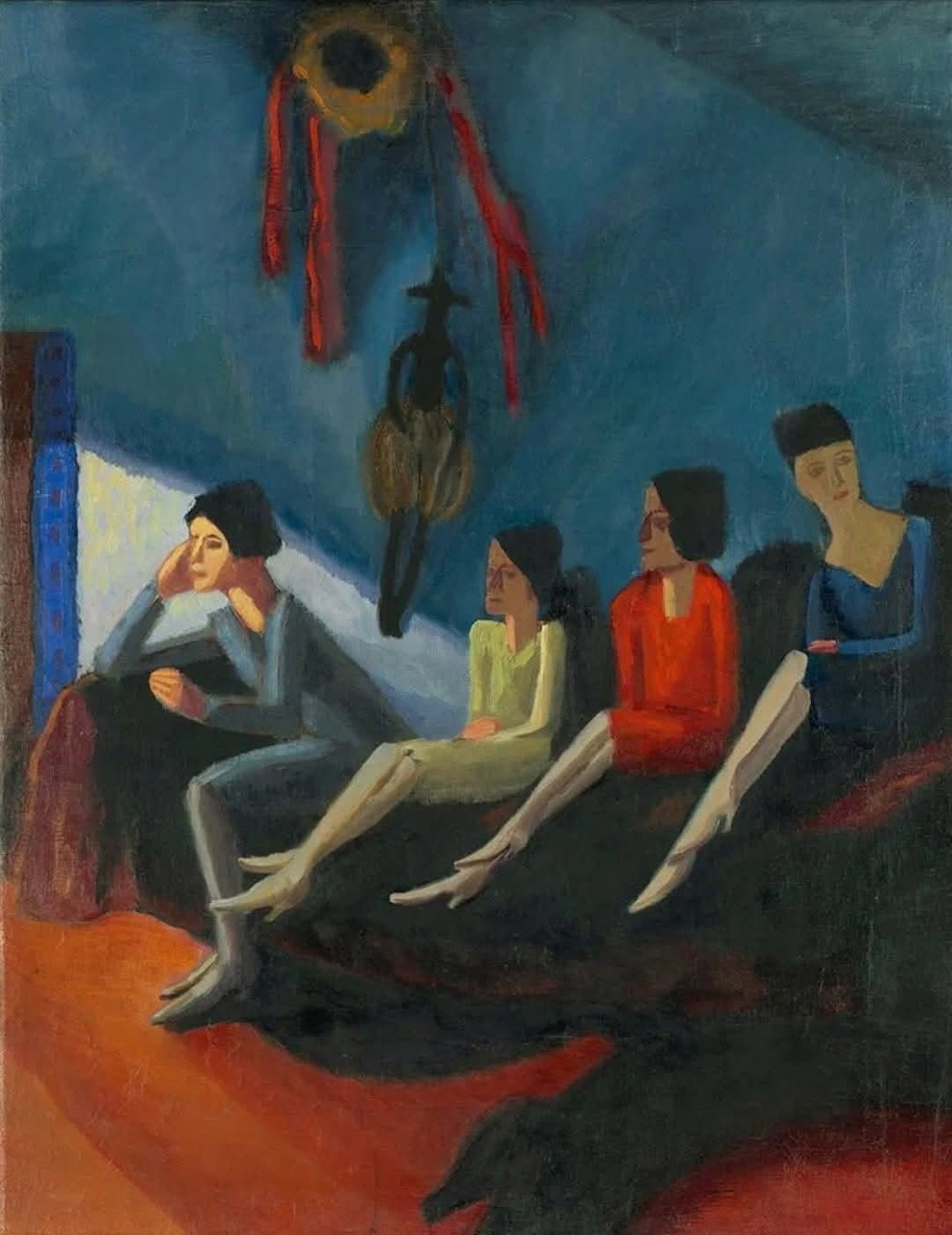 Expressionist painting showing four seated women in a blue room with dark furniture and vivid red accents