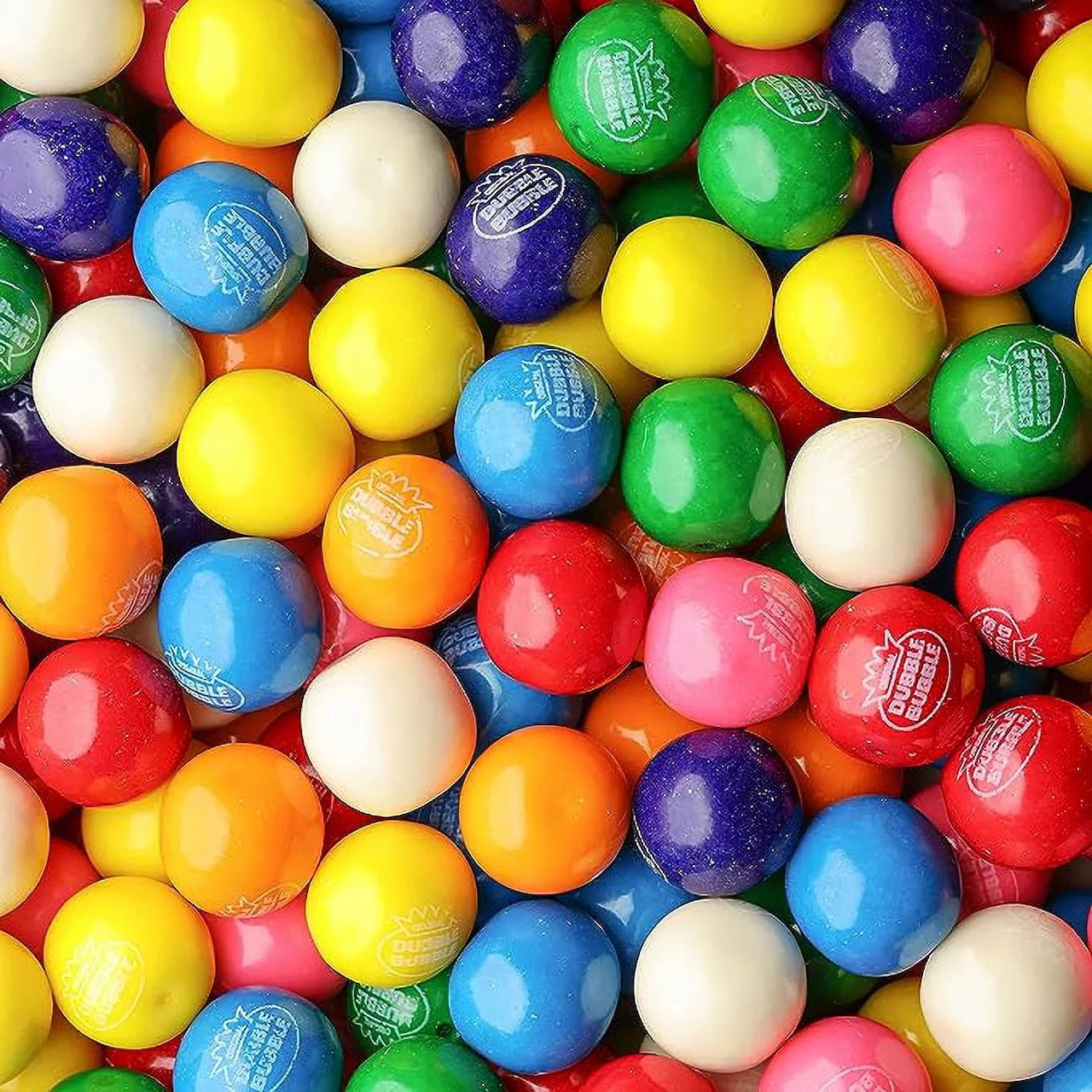 Colorful gumballs in various bright colors packed together