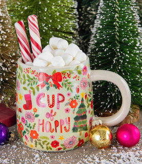 Floral mug with marshmallows and candy canes, surrounded by snowy mini trees and Christmas ornaments