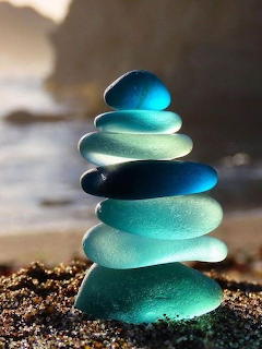 Stack of smooth gray pebbles balanced in a zen cairn