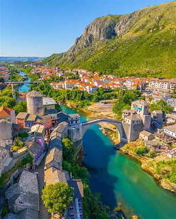Aerial view of Stari Most bridge in Mostar, Bosnia with turquoise river and old town buildings