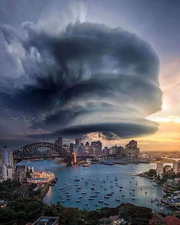 Large cloud above Sydney Opera House and Harbour Bridge skyline