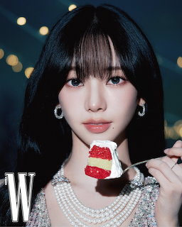 Portrait of a young woman with short black hair holding a fork with red velvet cake