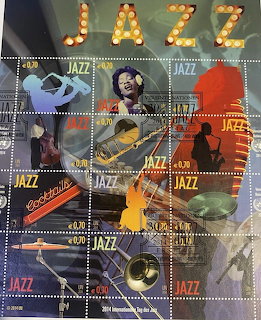 Sheet of jazz-themed postage stamps with musicians, instruments, and JAZZ lettering in lights at top