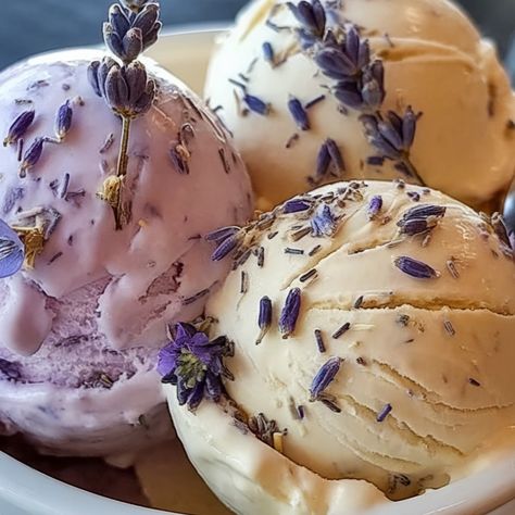Three scoops of lavender-garnished ice cream in pink, yellow and cream colors