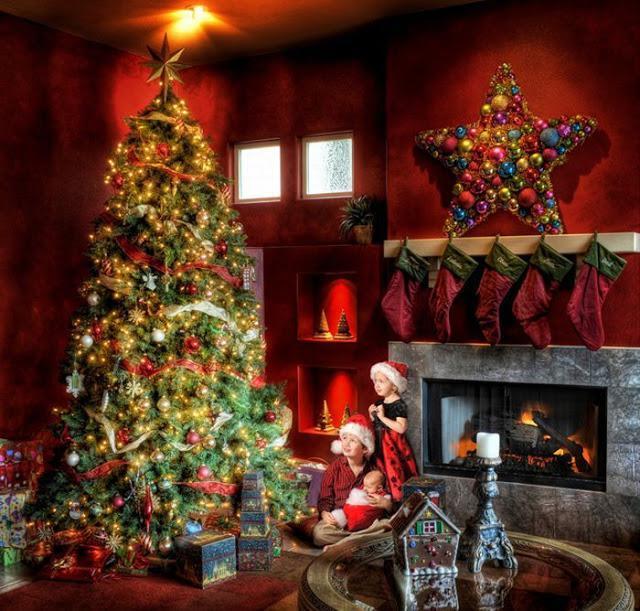 Cozy Christmas living room with illuminated tree, fireplace, and holiday decorations