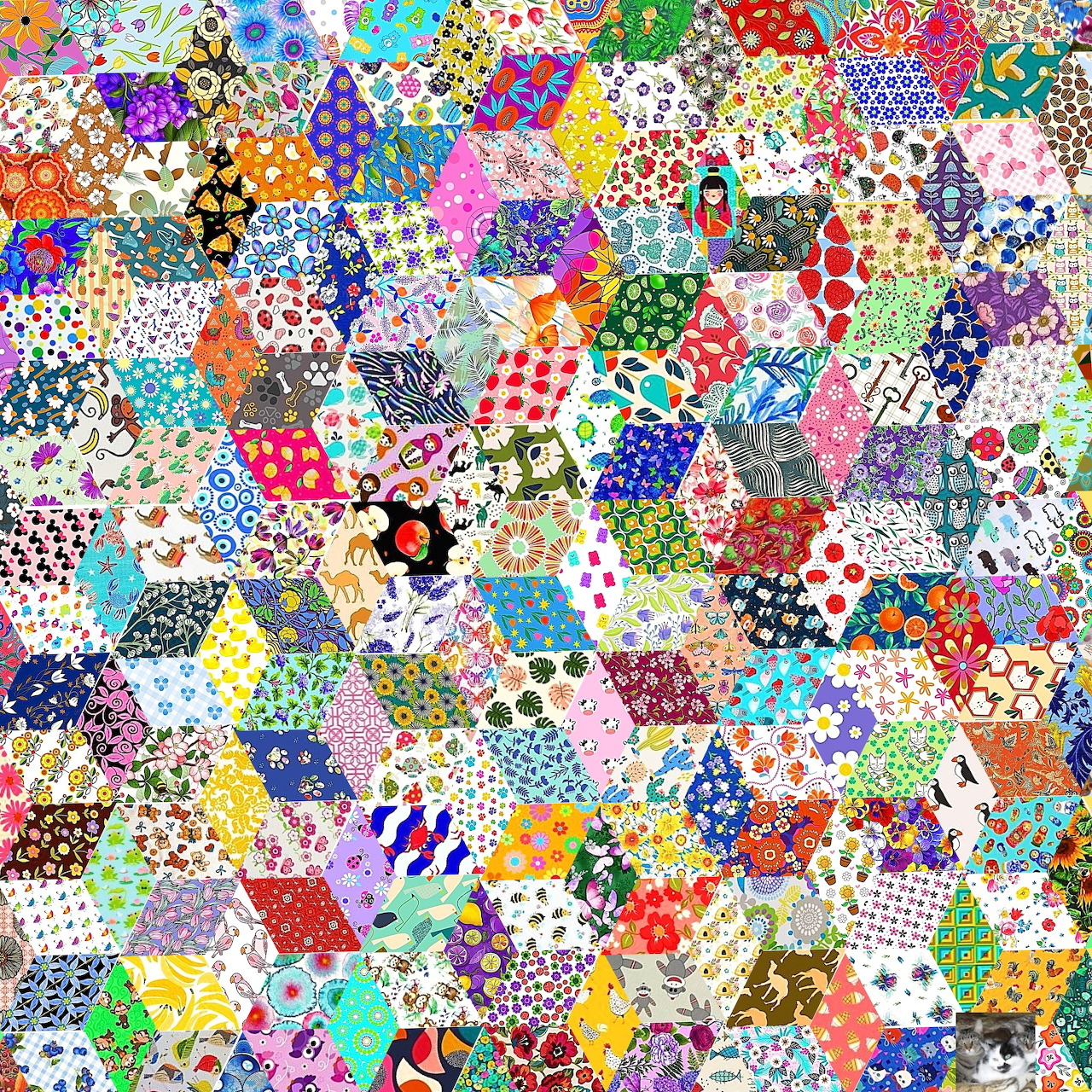 Colorful hexagonal patchwork quilt with hundreds of fabric patches in diverse patterns and colors