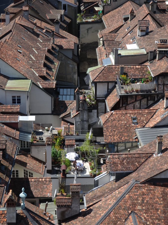 Aerial view of tightly packed terracotta rooftops and rooftop terraces in Bern, Switzerland