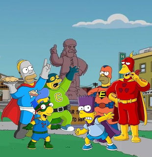 The Simpsons family in superhero costumes standing on grass with houses and Homer statue behind them