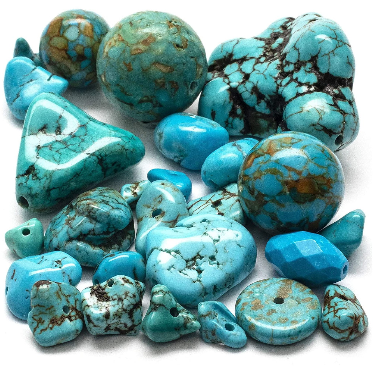 Assorted polished turquoise stones and beads on a white background