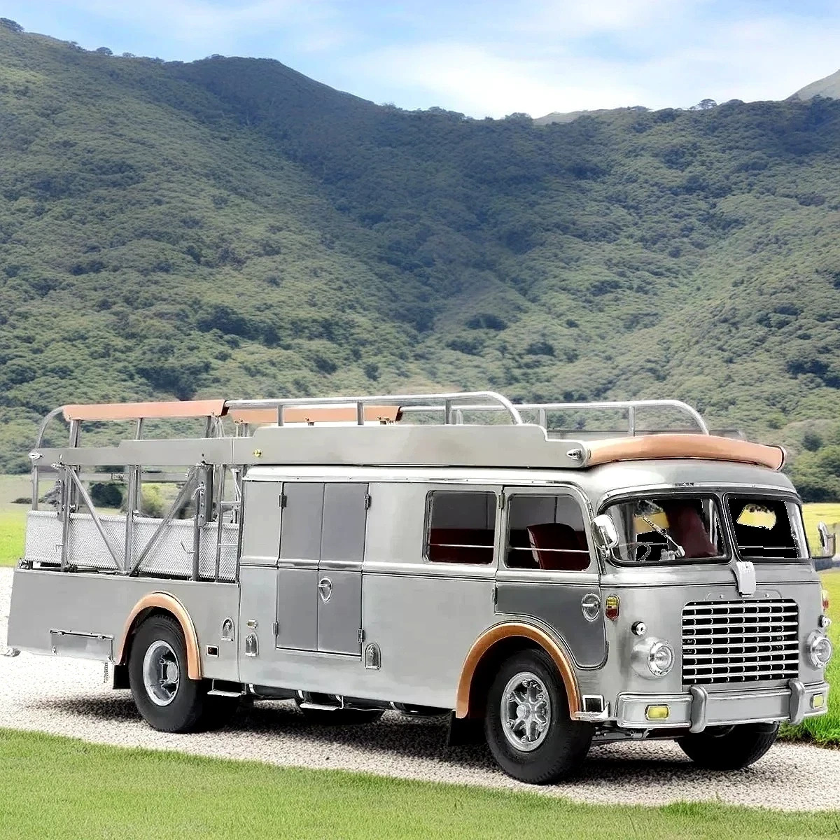 Silver vintage Fiat Bartoletti car transporter truck on grass with mountain backdrop