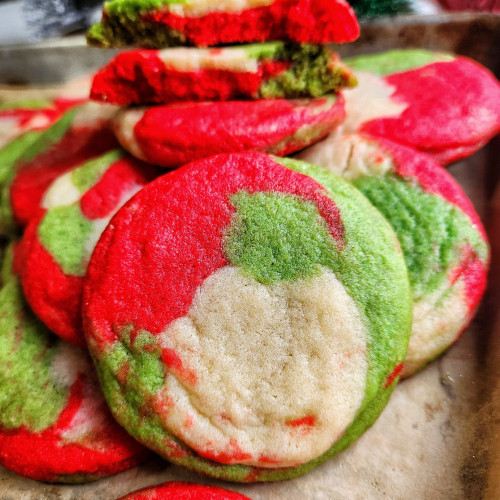 Red, green and white swirled Christmas sugar cookies on baking sheet