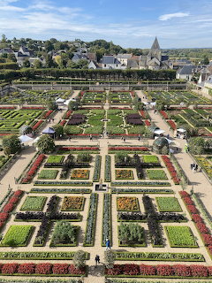 Aerial view of formal geometric gardens with colorful vegetable beds at Chateau de Villandry