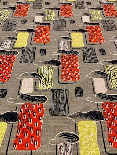 Mid-century modern fabric pattern with colorful abstract geometric shapes on gray background