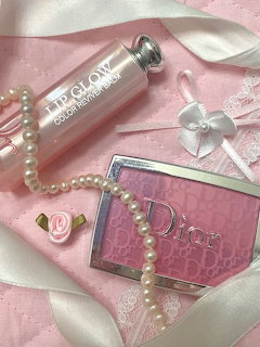 Pink Dior cosmetics with pearl necklace on white satin ribbons