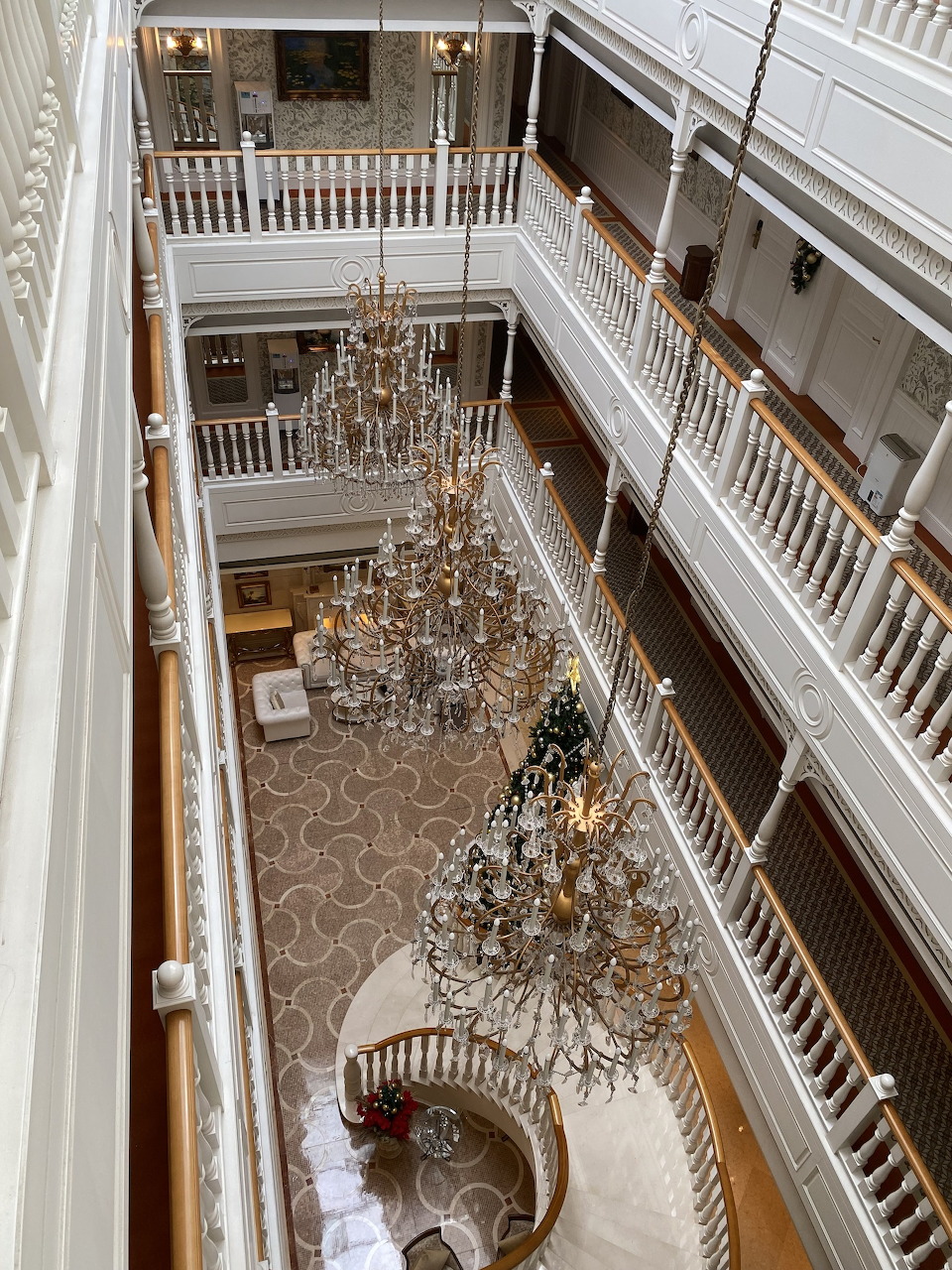 Ornate crystal chandeliers with golden lights and hanging glass beads