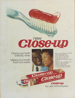 Vintage Close-Up toothpaste advertisement showing a smiling couple and a toothbrush with red toothpaste
