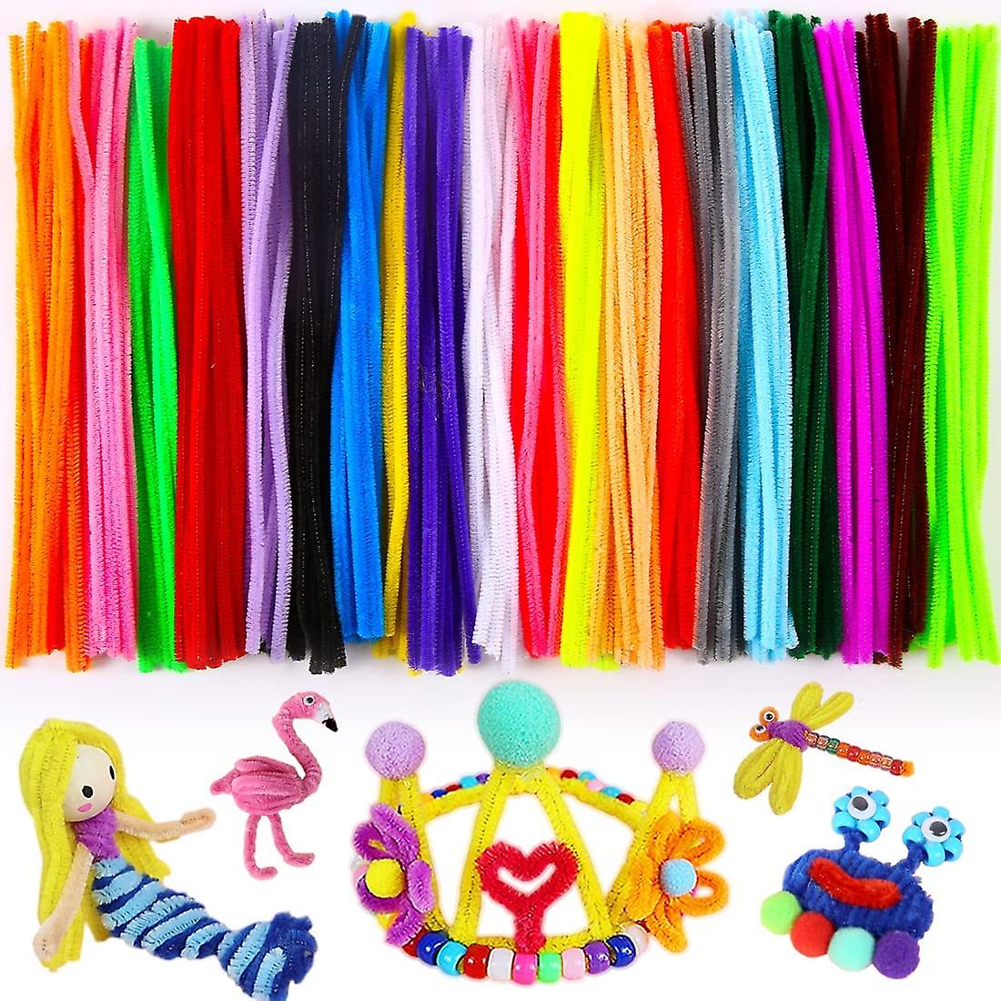 Assorted colorful pipe cleaners with small handmade craft sculptures including flamingo, dragonfly, and figures