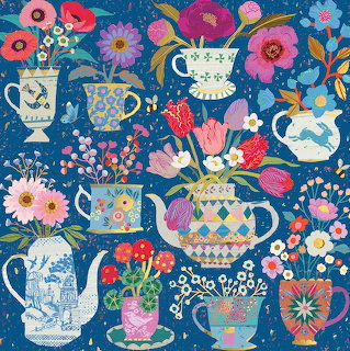 Colorful floral teapots and cups arranged in a pattern on blue background