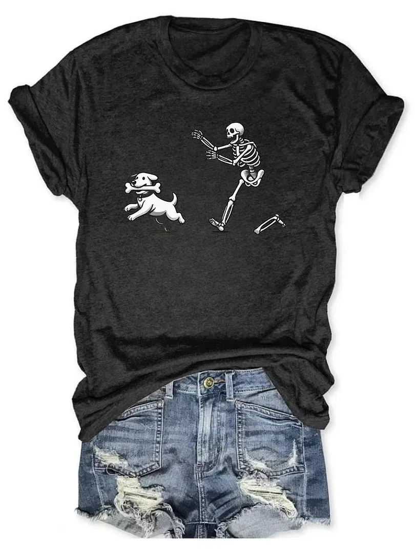 Gray t-shirt with skeleton chasing dog carrying bone graphic, laid on ripped jeans