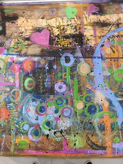 Colorful abstract painting with circles, splatters, lines, and a pink heart