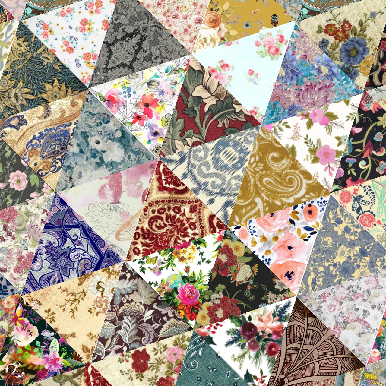 Colorful patchwork quilt with floral patterns, butterflies, and vintage fabric pieces arranged in triangular shapes