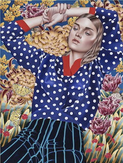 Painting of woman in blue polka dot top surrounded by flowers and geometric patterns in vibrant colors