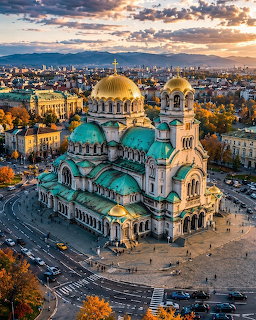 Aerial view of Alexander Nevsky Cathedral with golden domes and green roofs in Sofia at sunset