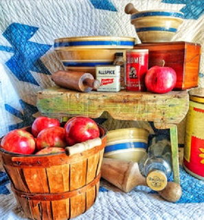 Apple pie baking ingredients with red apples, cinnamon and flour on a table