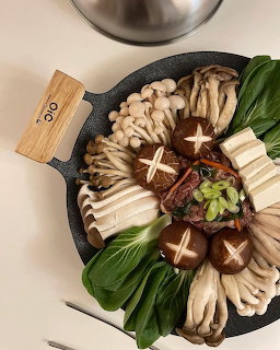 Overhead view of assorted Korean food dishes with rice and kimchi