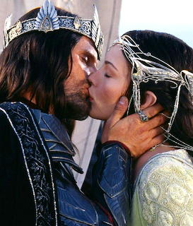 Aragorn and Arwen kissing while wearing silver crowns in Lord of the Rings scene