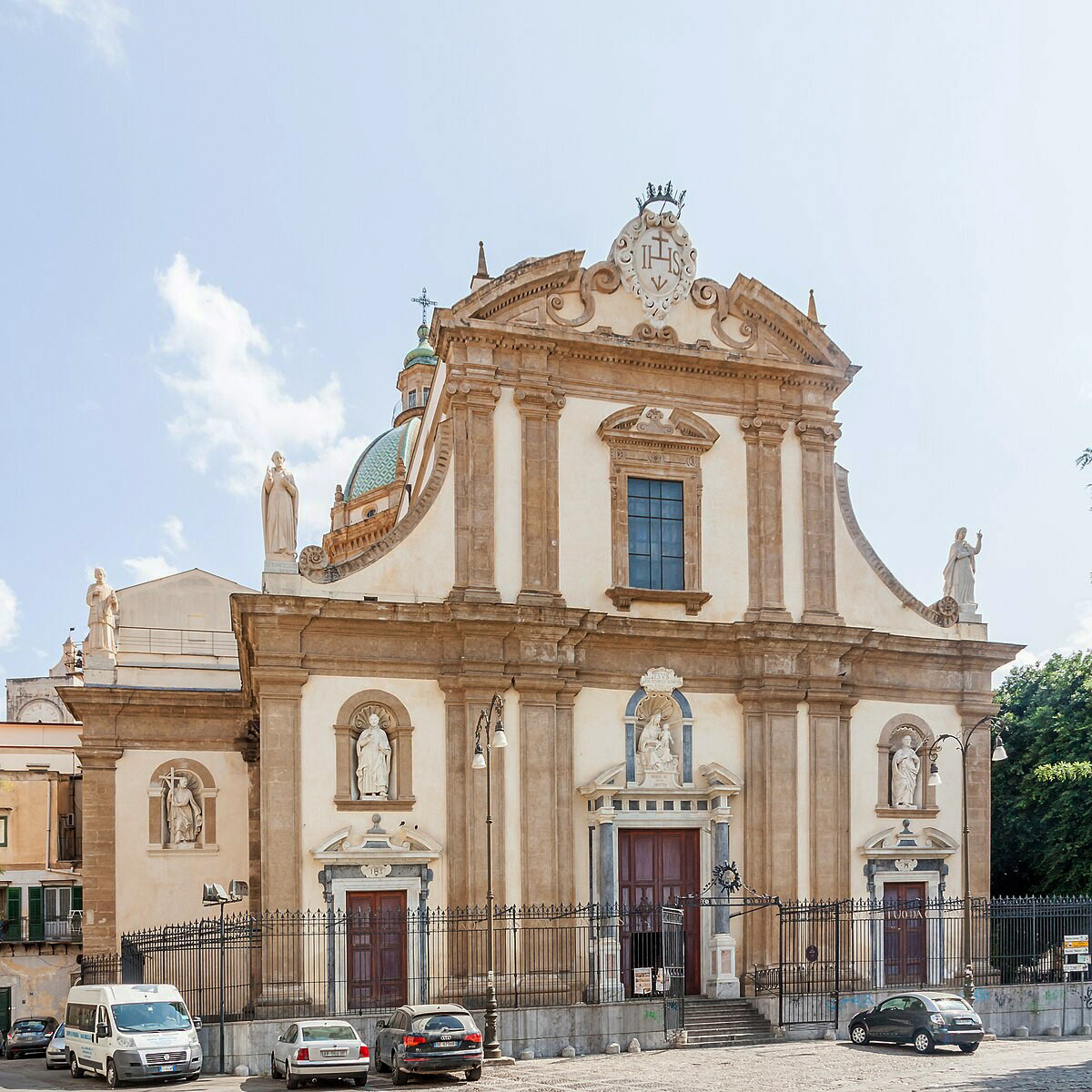 Baroque church facade of Chiesa del Gesù in Palermo with statues, columns, and green dome