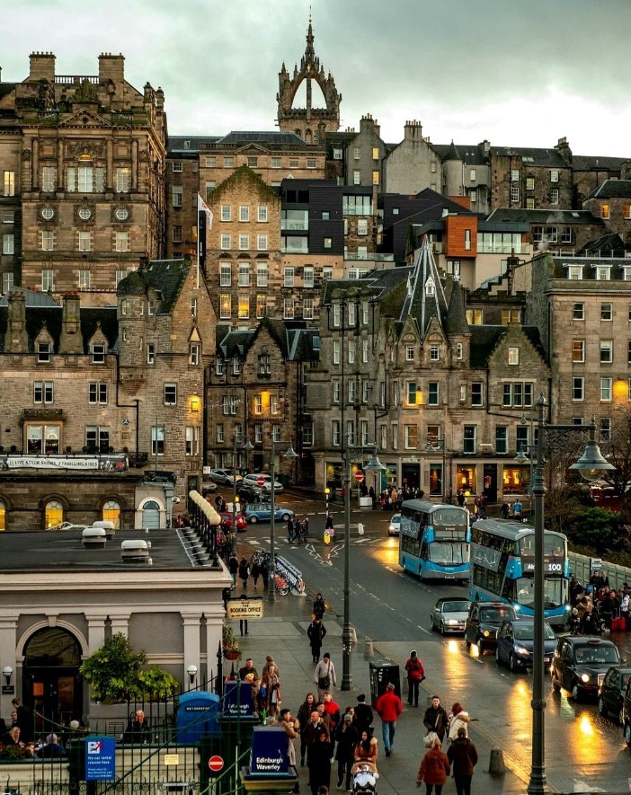 Edinburgh Old Town buildings and street at dusk with wet pavement and cloudy sky