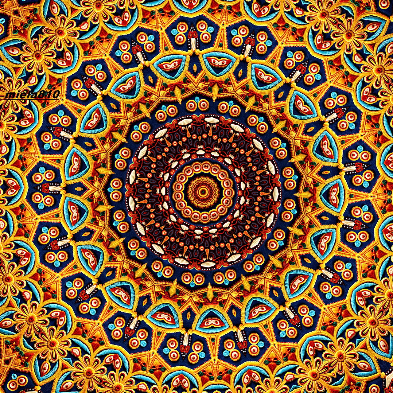 Circular mandala with ornate geometric patterns in orange, teal, and burgundy colors