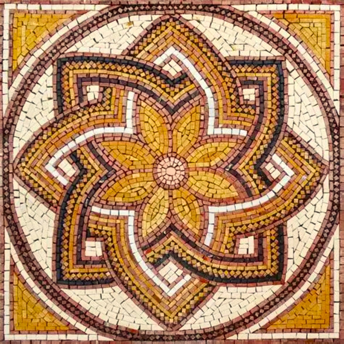 Decorative mosaic showing golden flower pattern with brown geometric borders on cream tiles