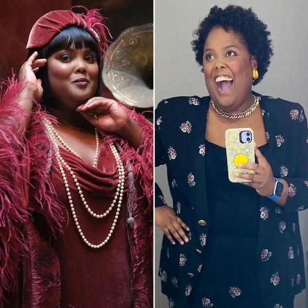 Two women side by side, one in burgundy period costume with headwrap, one in blue modern dress holding microphone