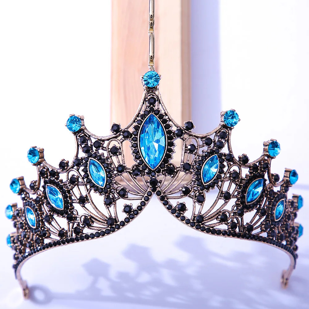 ornate silver tiara with blue gemstones on a light background