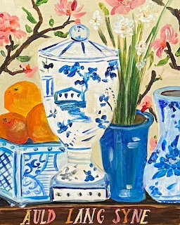 Colorful still life painting with blue willow porcelain, oranges, and flowers arranged on a patterned table