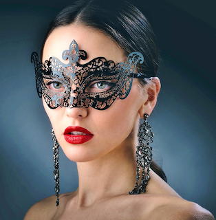 Woman with dark hair wearing ornate black lace masquerade mask, red lipstick, and chandelier earrings