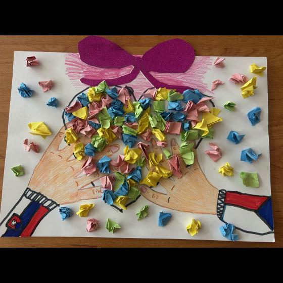 Colorful heart made of candy wrappers on a hand-drawn page with a purple bow and illustrated sleeves