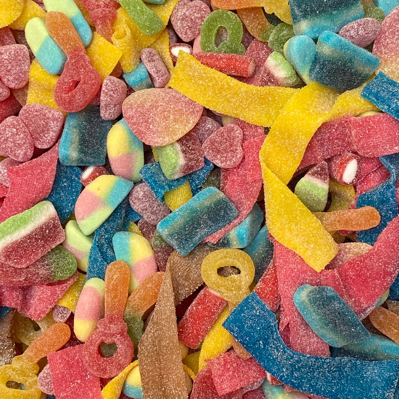 Colorful assorted gummy candies with sugar coating in various shapes