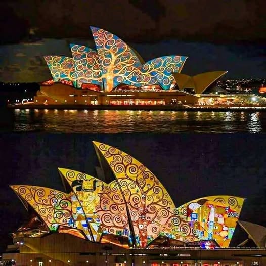 Sydney Opera House lit with vibrant Klimt-style decorative patterns at night with water reflection