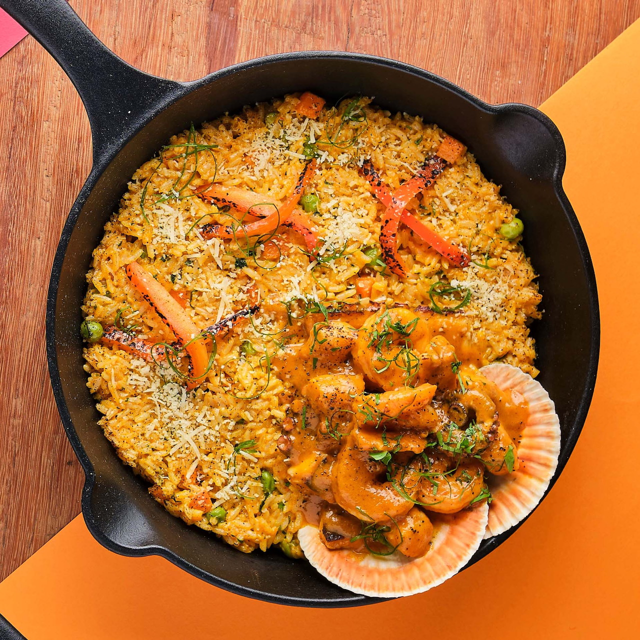 Overhead view of seafood paella with shrimp in a cast iron pan