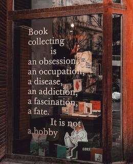 Bookshop window with text reading Book collecting is an obsession, an occupation, a disease, an addiction, a fascination, a fate