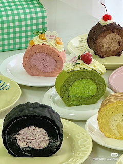Assorted colorful Japanese roll cake slices on plates with cream fillings in various flavors