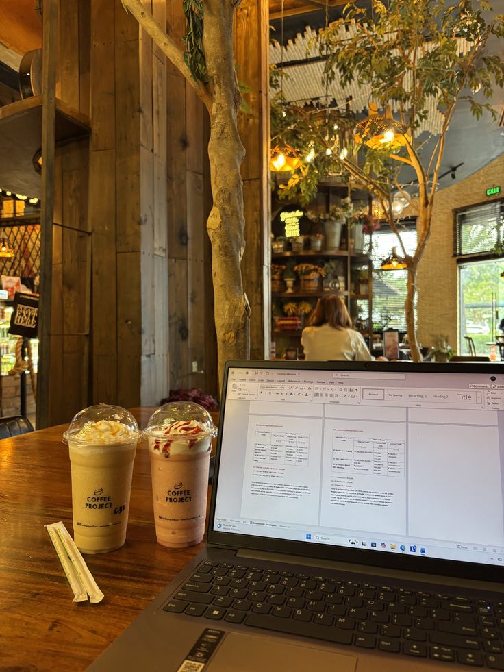 Person studying with notebook and coffee at a cafe table