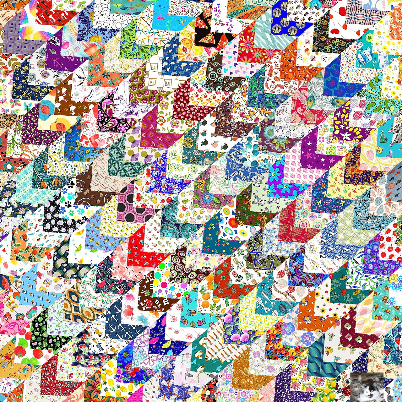 Dense colorful patchwork quilt with zigzag fabric pieces in various patterns and bright colors
