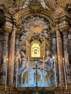 Baroque marble altar with angel sculptures and golden icon shrine inside Ravenna Cathedral
